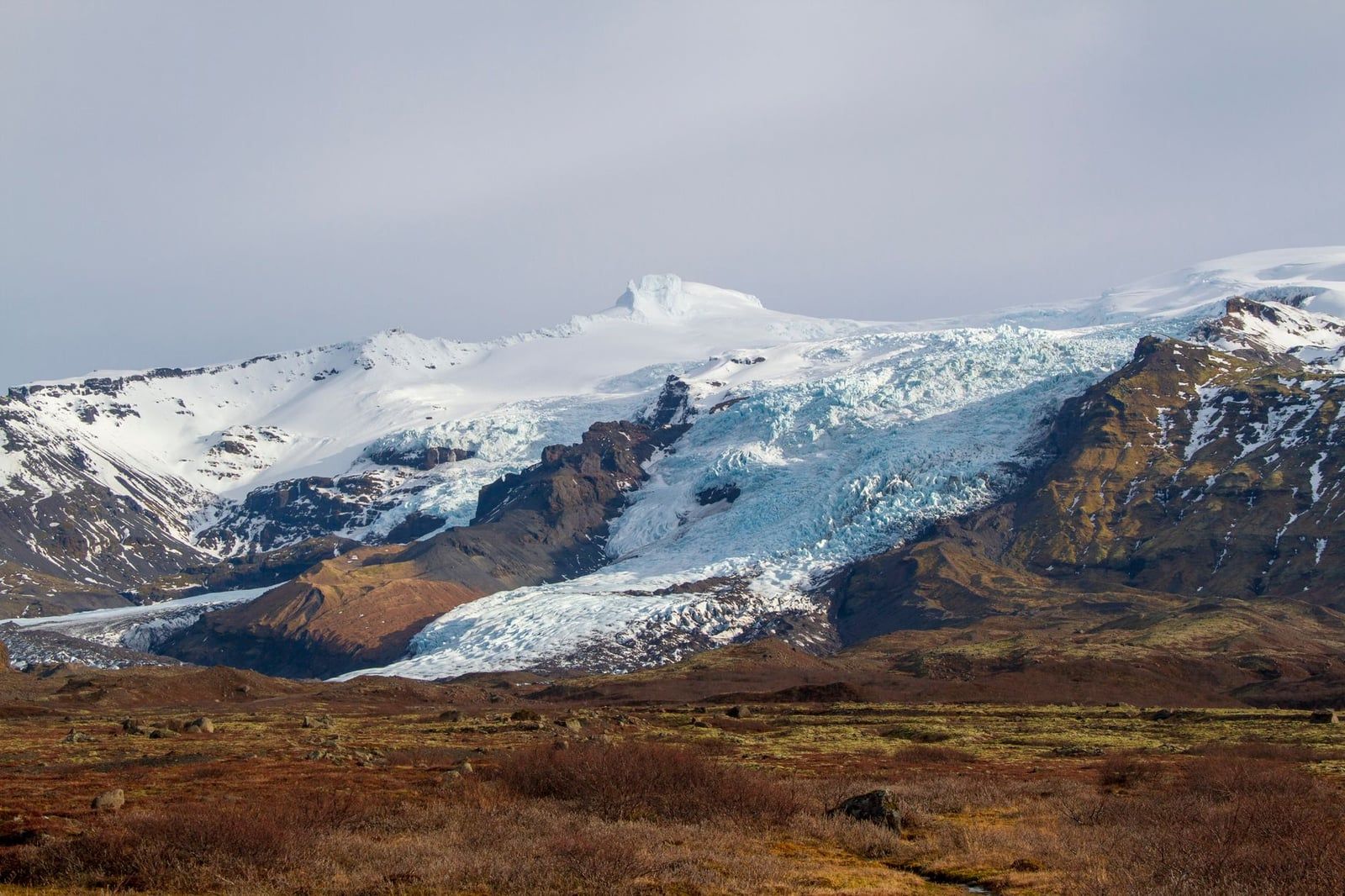 The dramatic icefall of Falljökull cascades down the rugged volcanic slopes of Vatnajökull Glacier.
